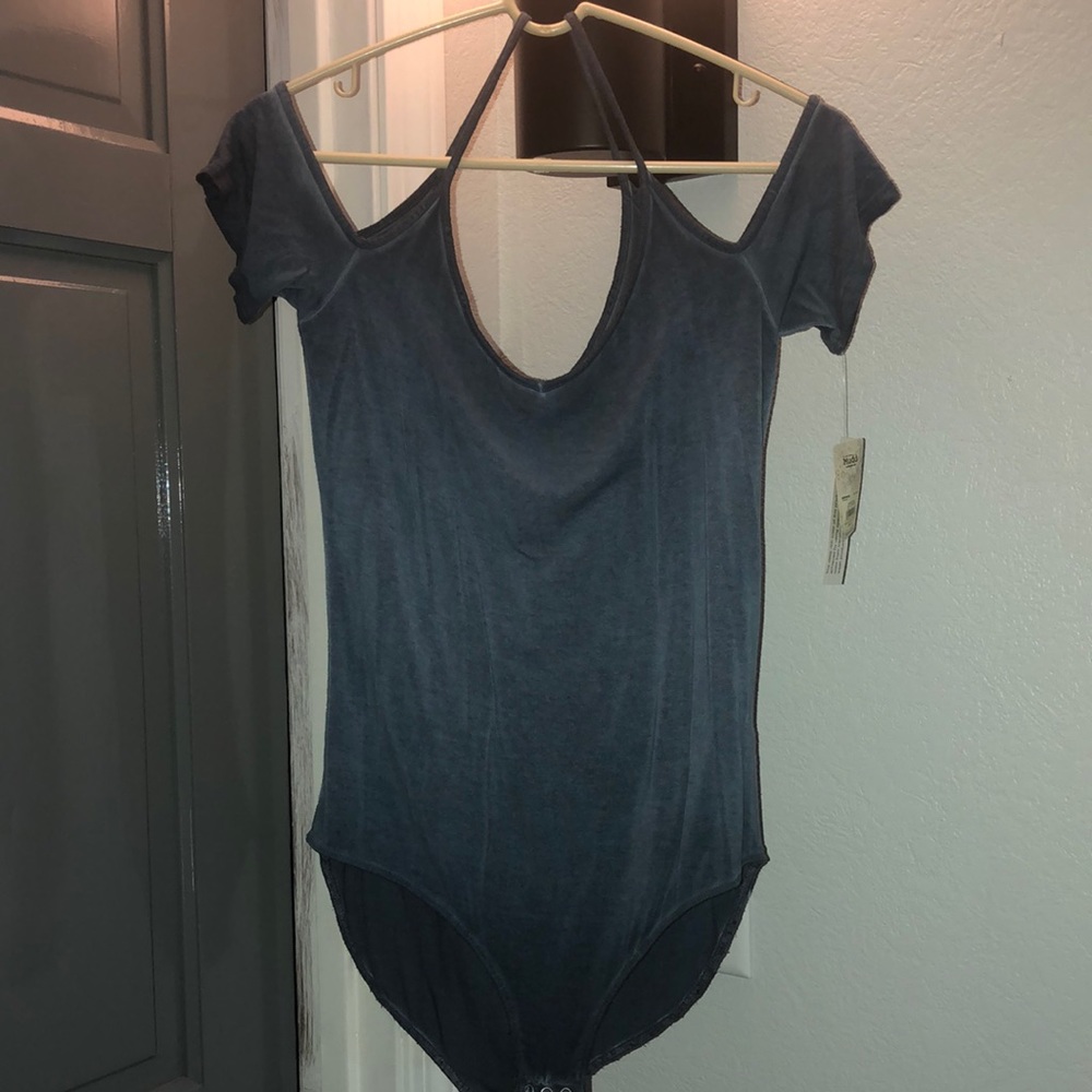 Blue body suit. Short sleeve and open shoulder. Size large. Snaps at bottom